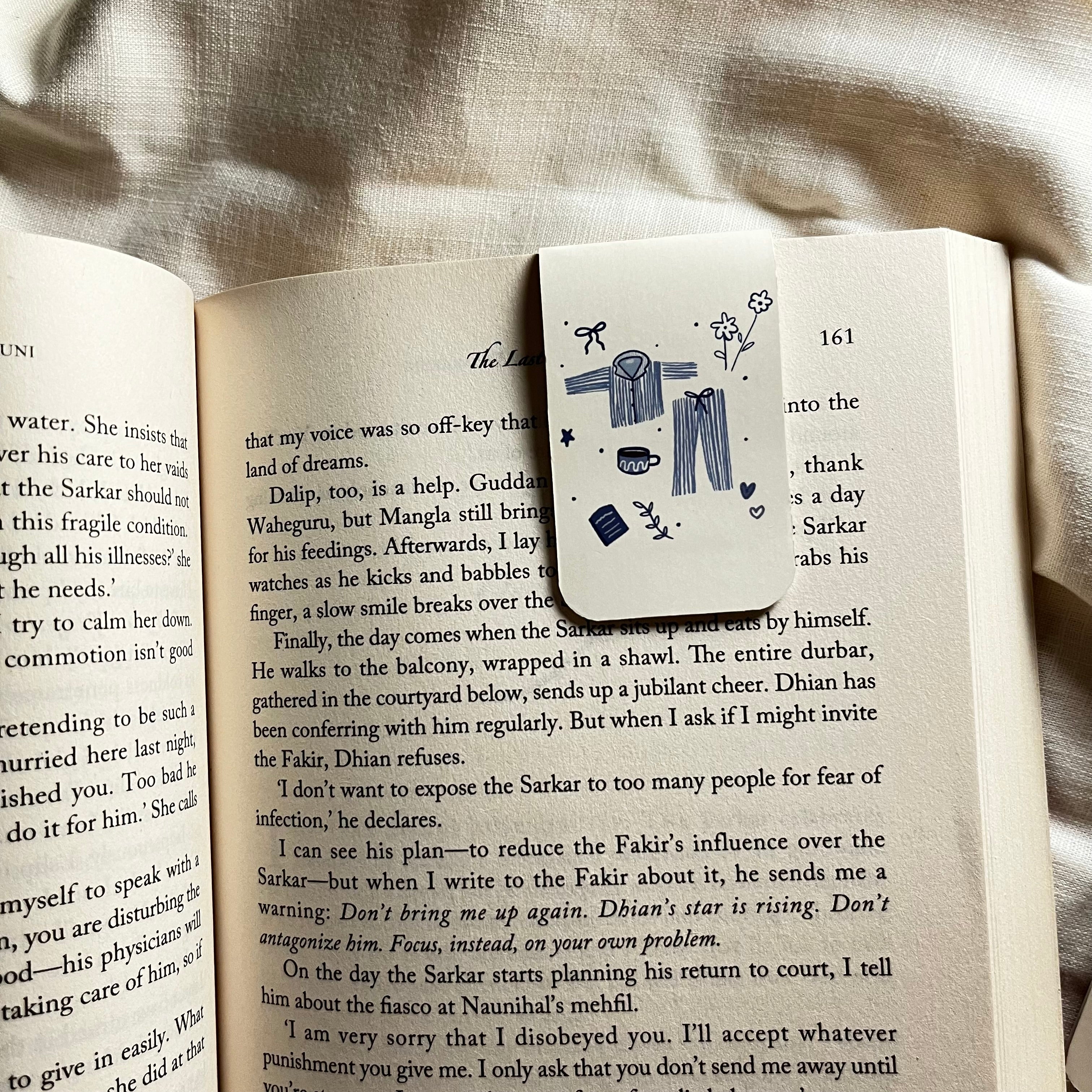 Decorative bookmark with illustrations on an open book
