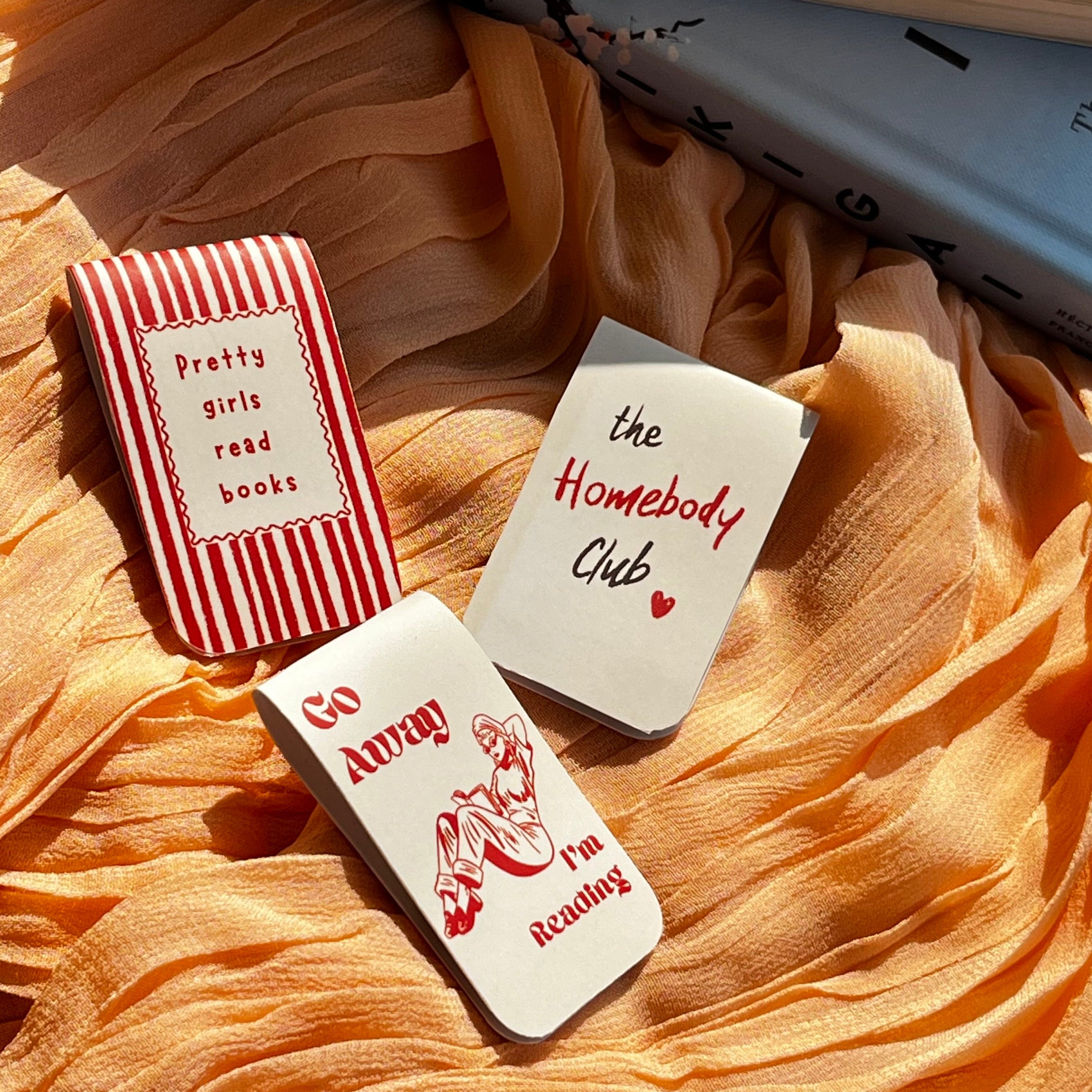 bookmarks set with humorous sayings on a soft fabric background