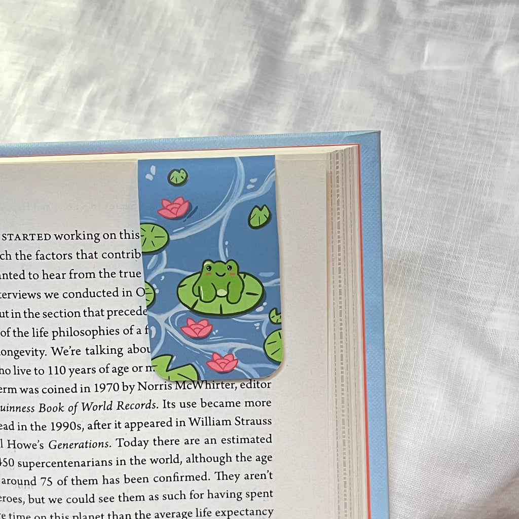 bookmark frog illustration on a white fabric background