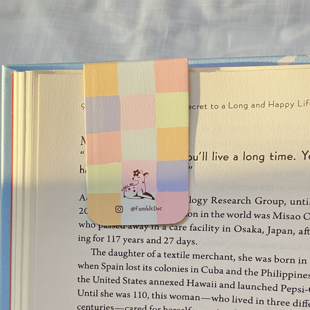 Colorful checkered bookmark with a dog illustration on a book page.
