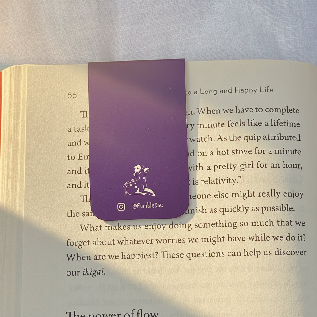 Open book with a purple bookmark on a textured surface