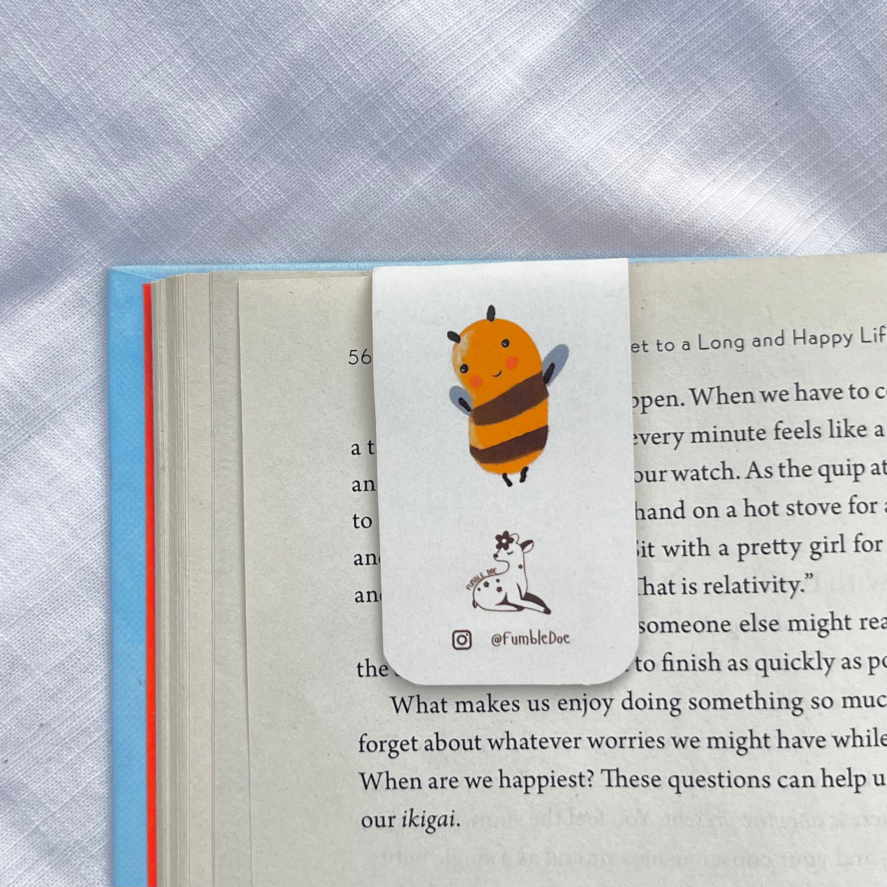 Bee bookmark with fumbledoe logo on a book