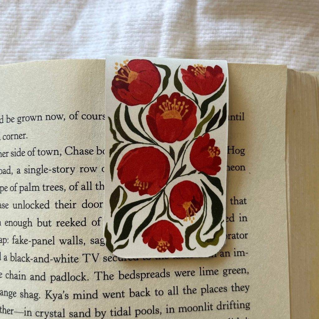 Decorative bookmark with floral design on an open book