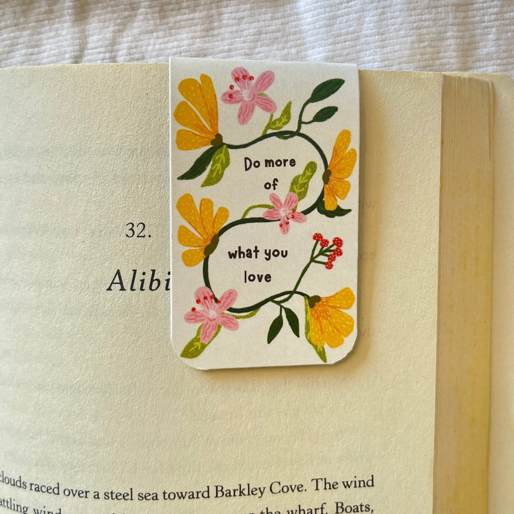 Floral bookmark with motivational quote on an open book