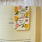 Floral bookmark with motivational quote on an open book