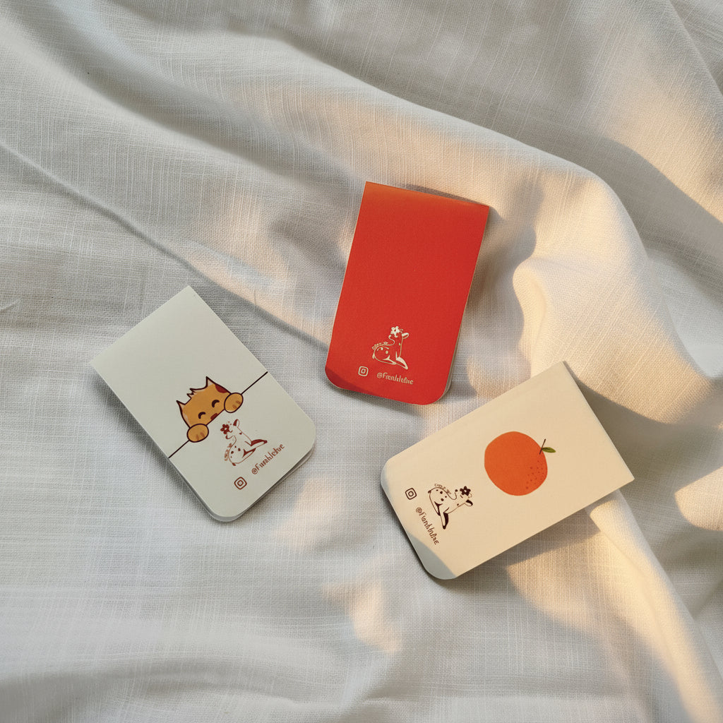 Three small cards with illustrations on a white fabric background